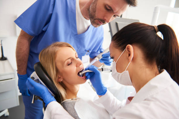 Root-canal-treatment-and-dentist-and-its-assistant-doing-root-canal-of-patient